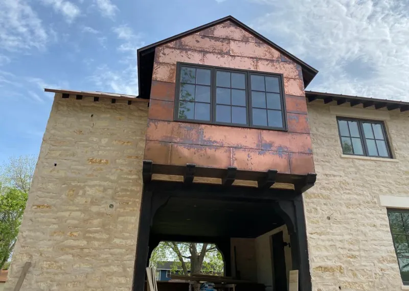 Copper metal panel facade on a stone building for Skylight Installation in Ruston