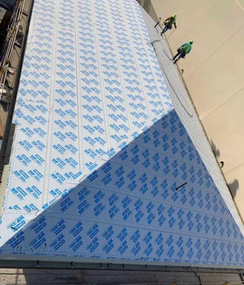 Professional roofers installing underlayment on a metal roof in Ruston